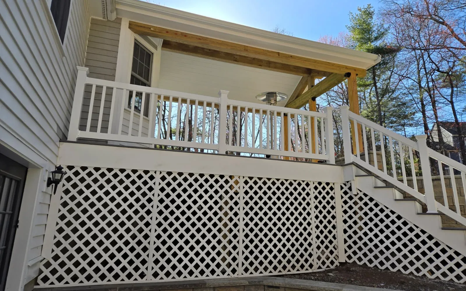 Older multi-family house with front porches on a hillside street in Gardner, Massachusetts