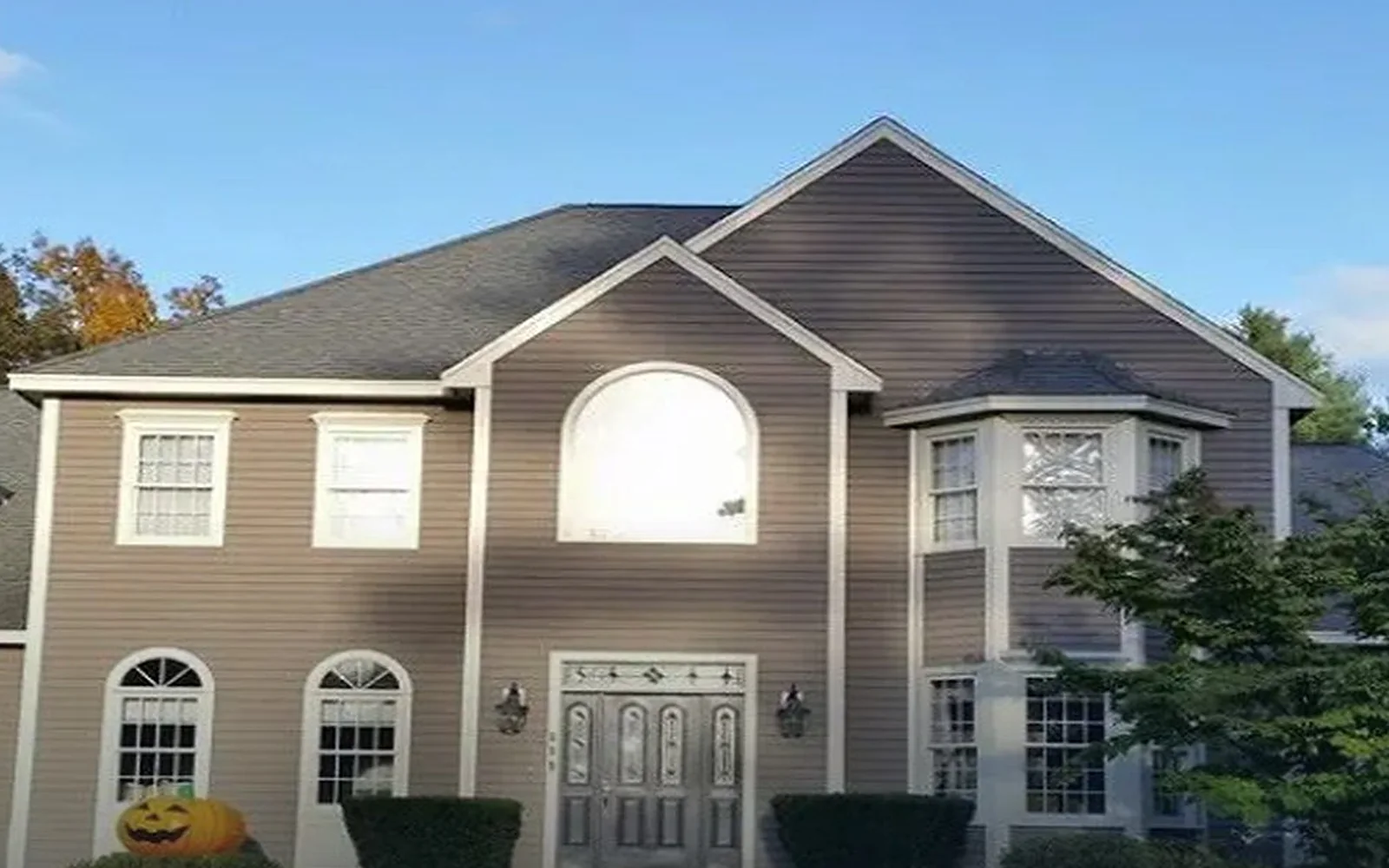 Colonial home with gray and beige siding in Leominster, Massachusetts