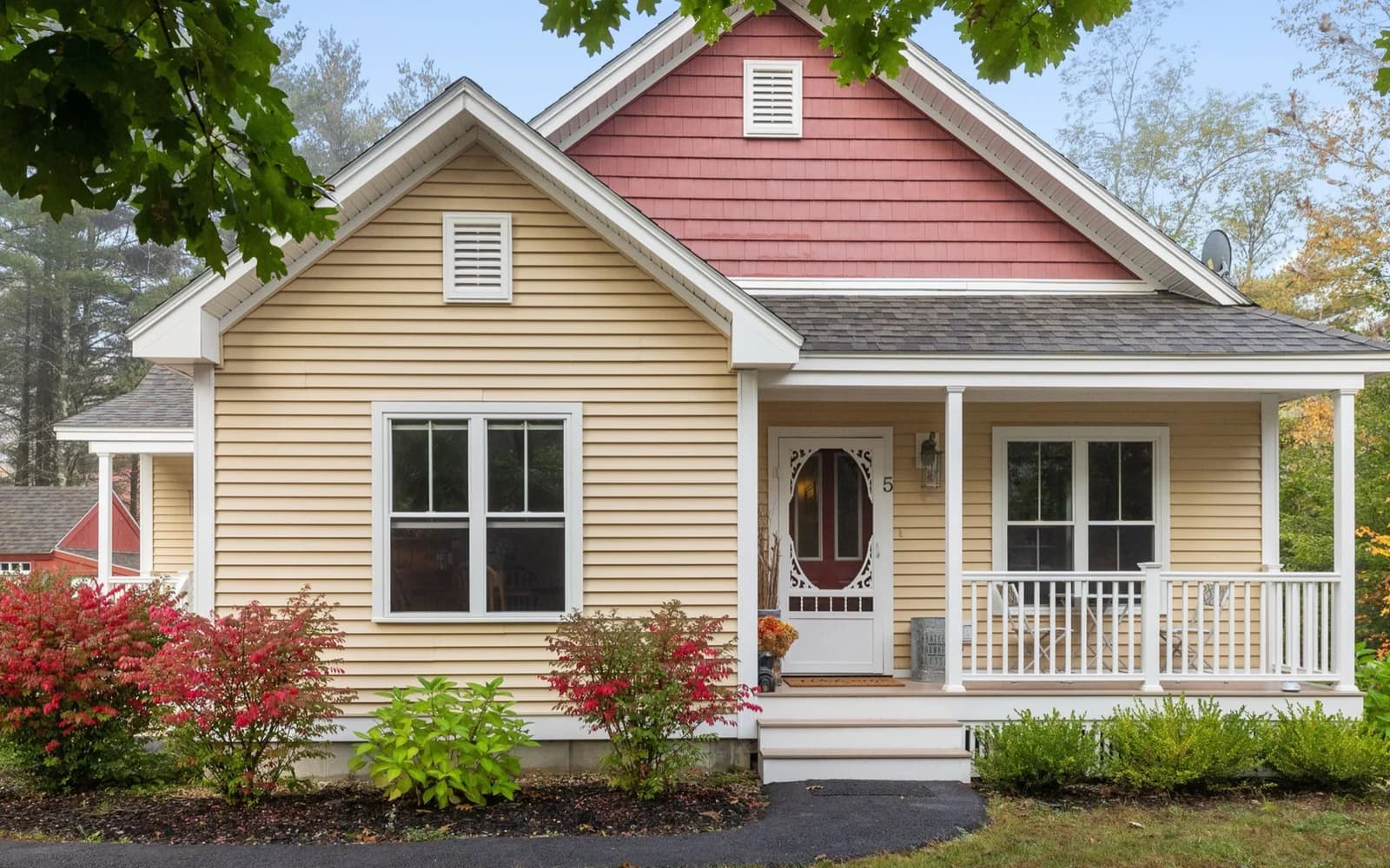 Colonial style home with gray and beige siding in a wooded Central Massachusetts setting like Westminster