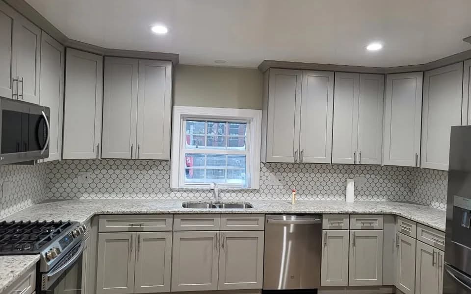 Detail of a finished kitchen remodel with wood cabinetry and granite countertop