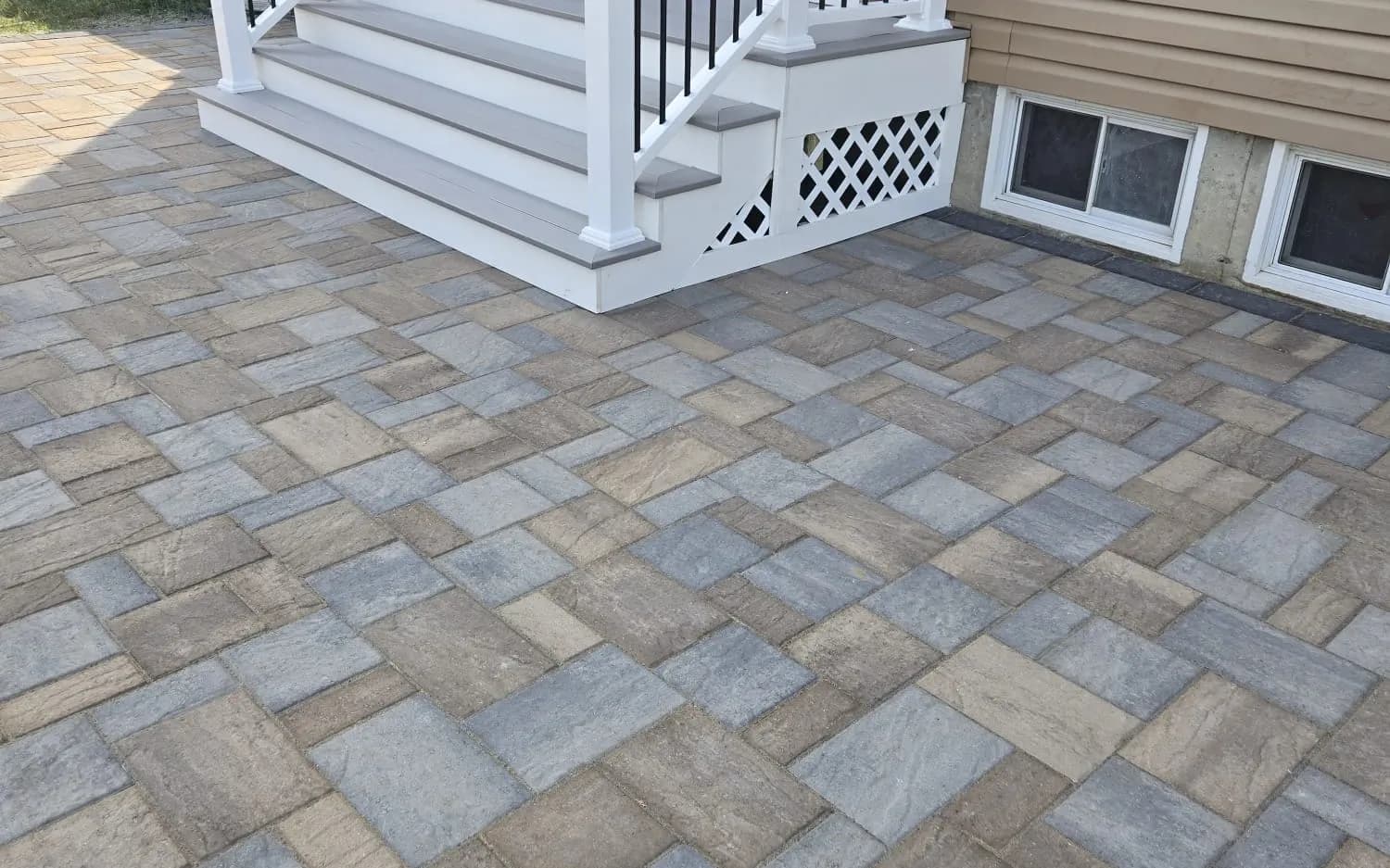 Paver patio with new composite steps and white railing