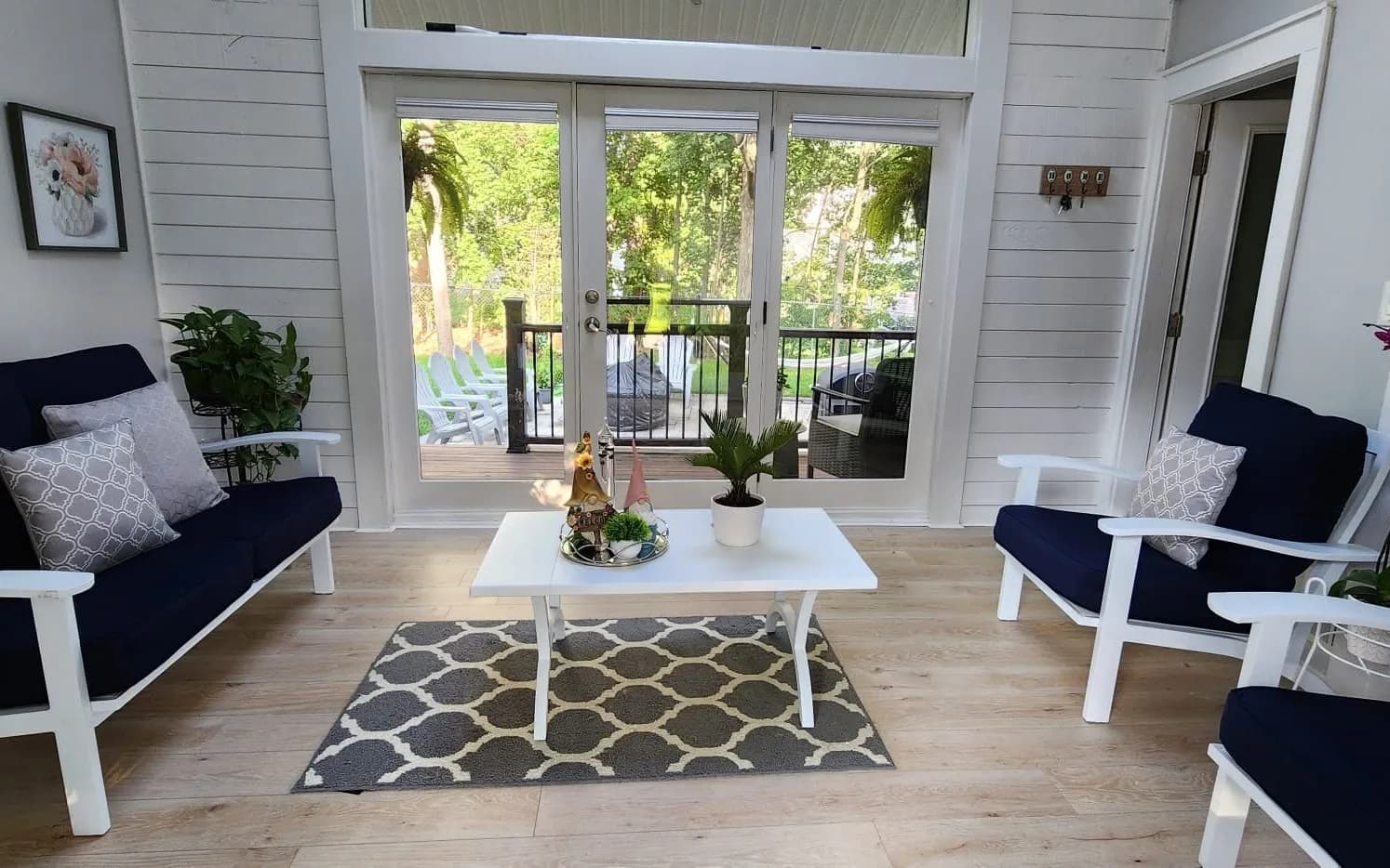 Bright sunroom renovation with new windows and sliding doors to the deck